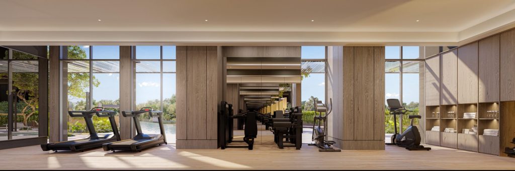 Indoor gymnasium with treadmills and strength equipment overlooking the pool at The Serra Residences, Novena